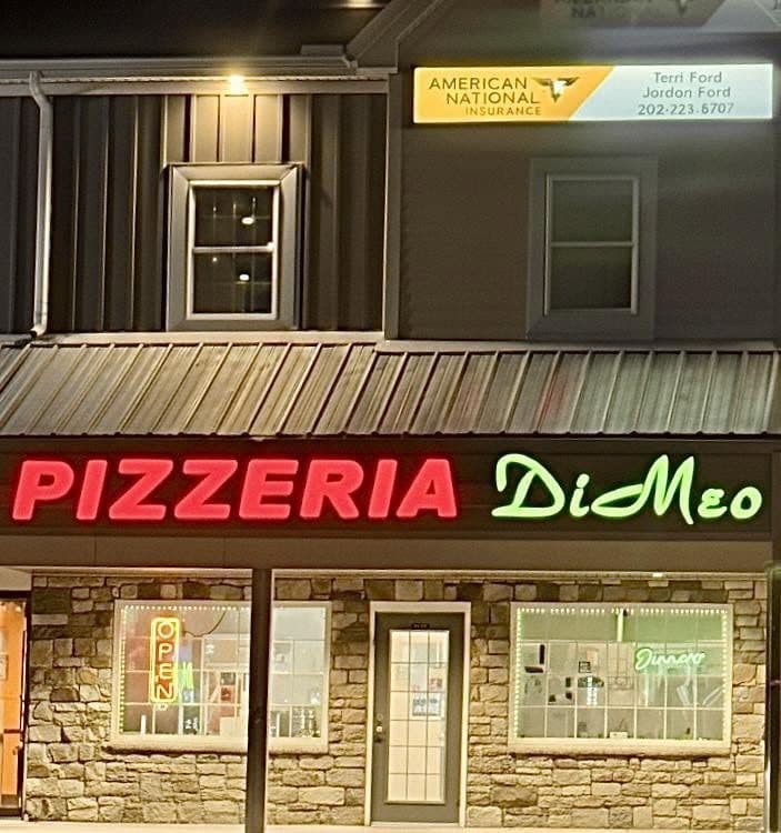 Pizzeria DiMeo neon sign lit up at night