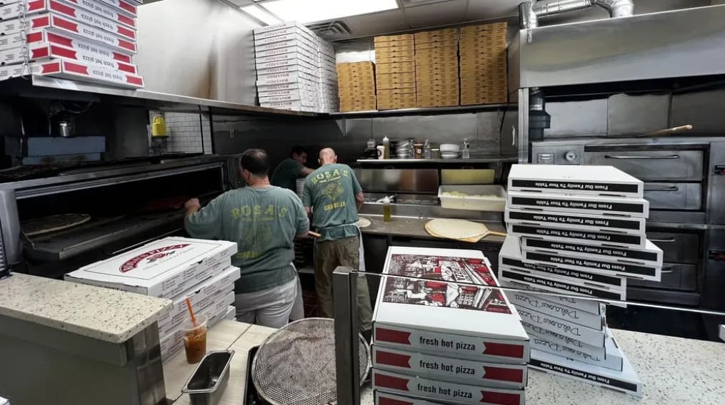 The kitchen at Rosa's Pizza with stacks of pizza boxes