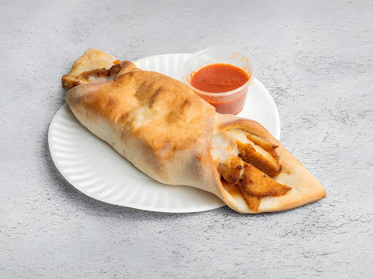 A roll with a cup of sauce