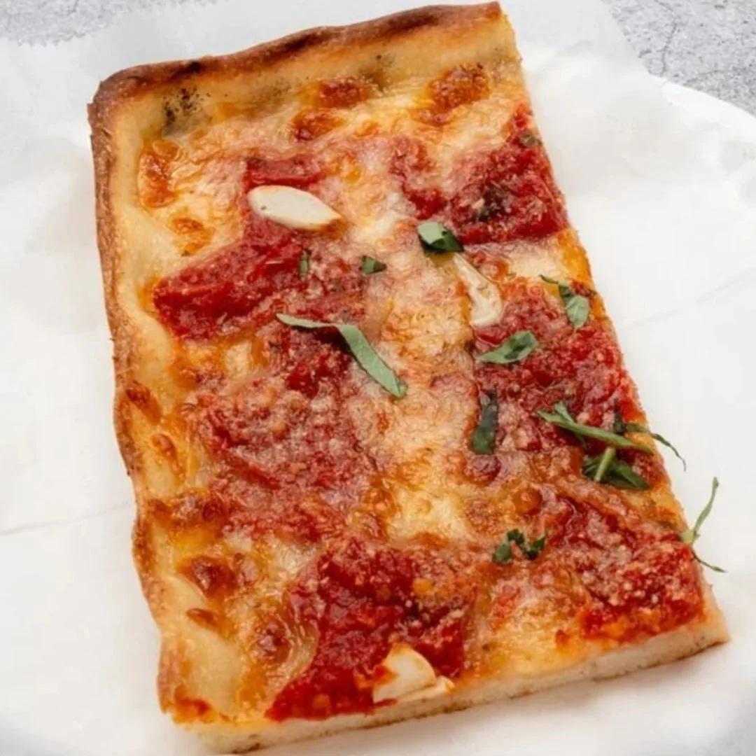 Square Sicilian slice with sauce on top