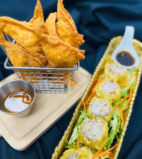 Crispy wontons and steamed dumplings with dipping sauces