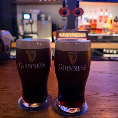 Two pints of Guinness at the bar