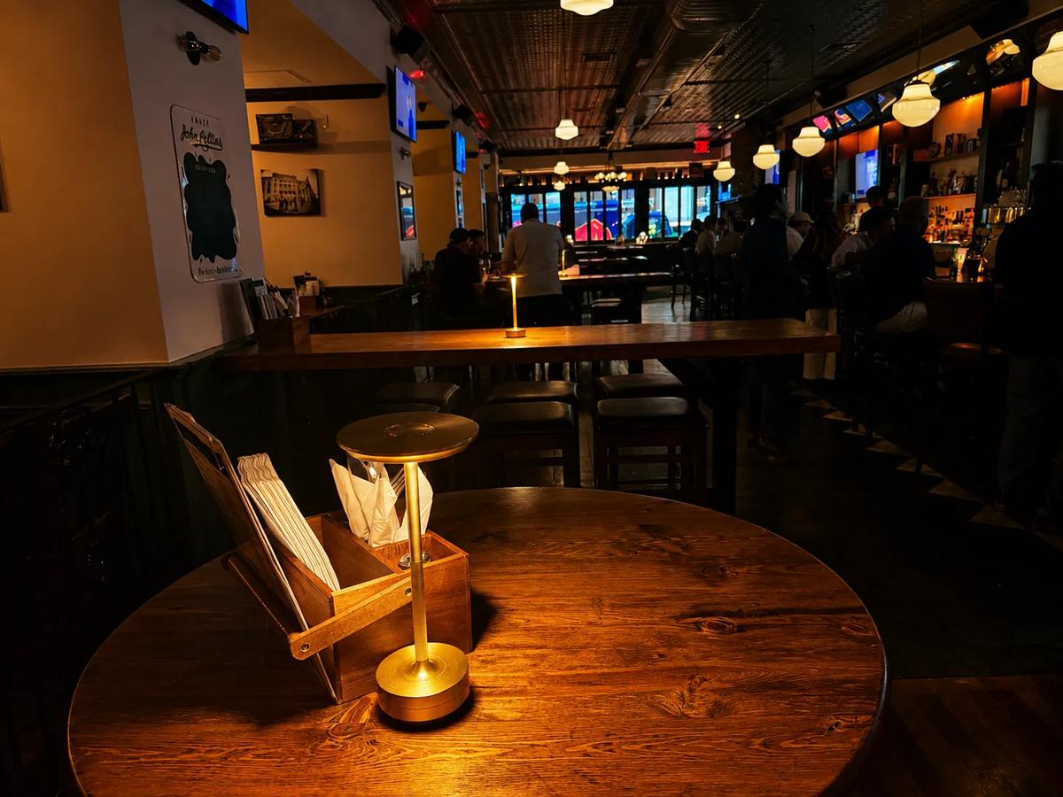A candlelit table looking down the bar