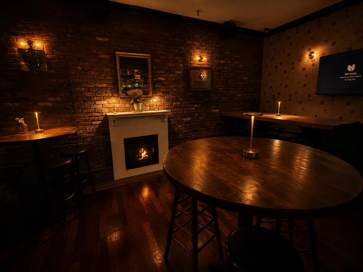 The fireplace room with round wooden tables