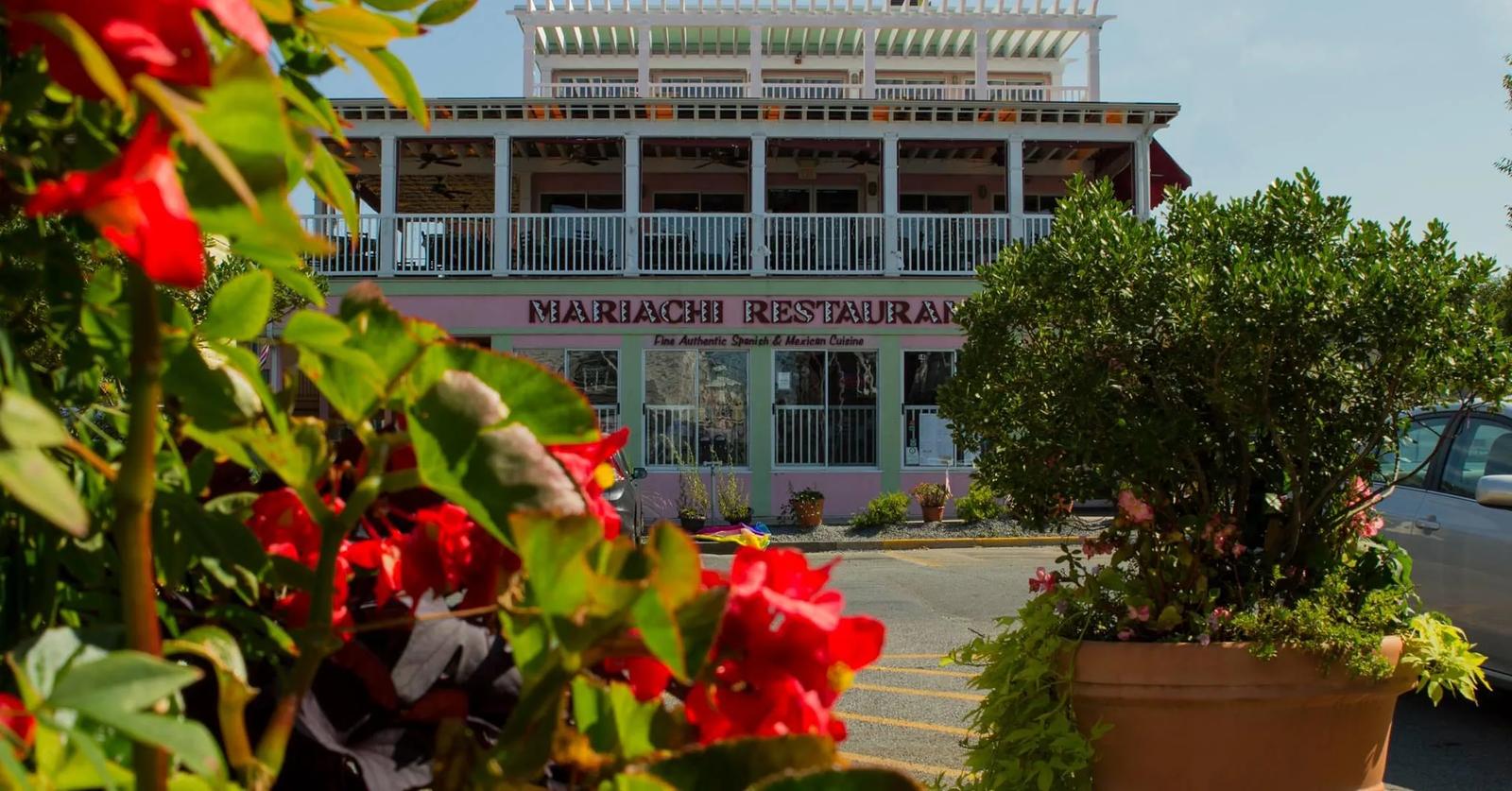 Mariachi Restaurant's building with red flowers in front