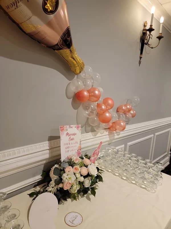 A champagne bottle balloon display at an engagement party