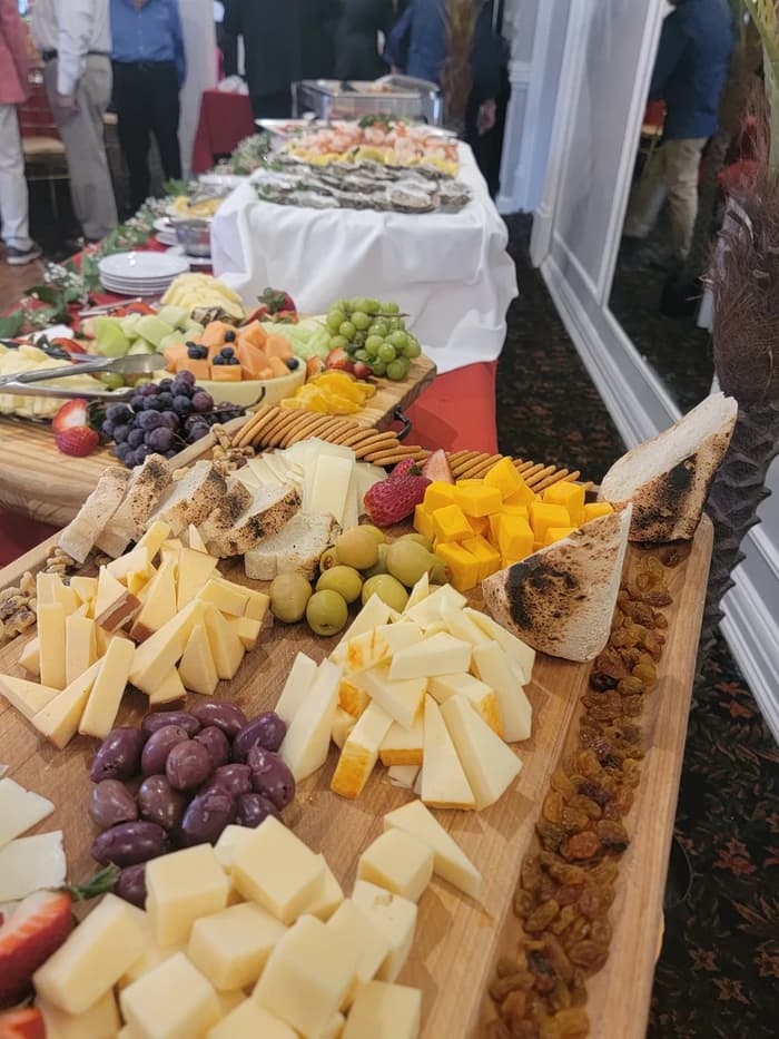 A fruit and cheese board with grapes and cubes of cheese