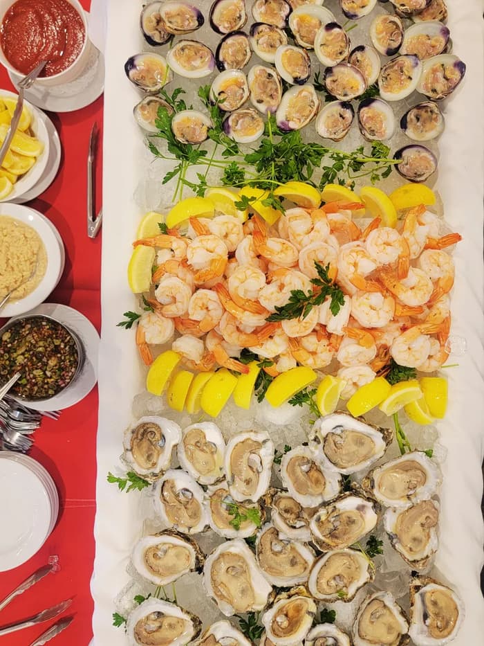 A cold seafood bar with shrimp, oysters and lemons