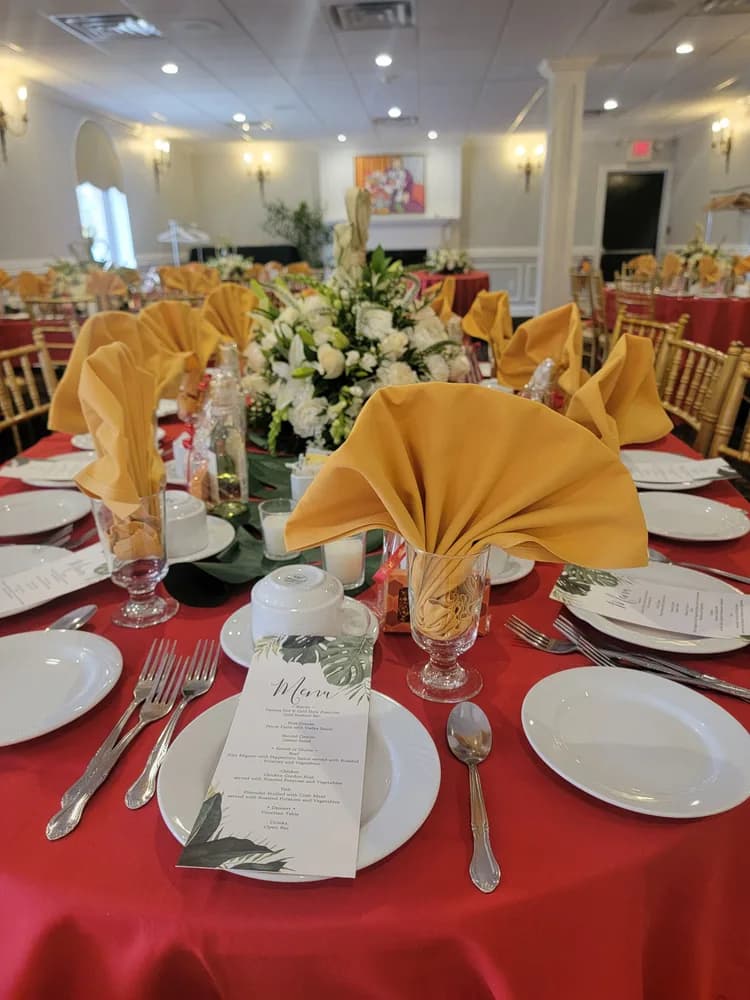 Gold napkins and white lilies on a red tablecloth