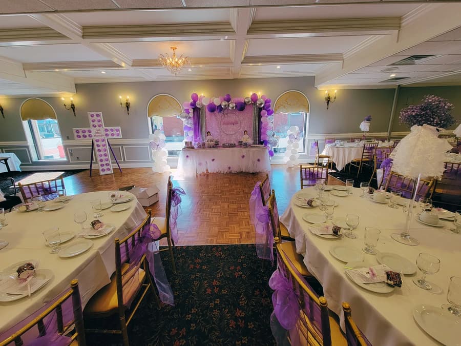 The banquet room set for a communion with lilac chair sashes