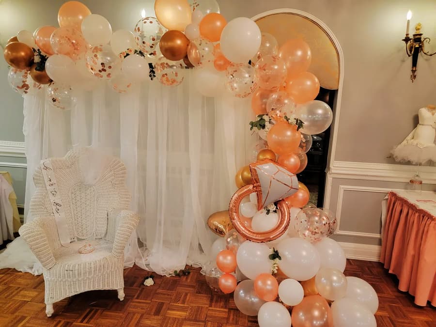 A balloon arch and flower wall for an engagement party